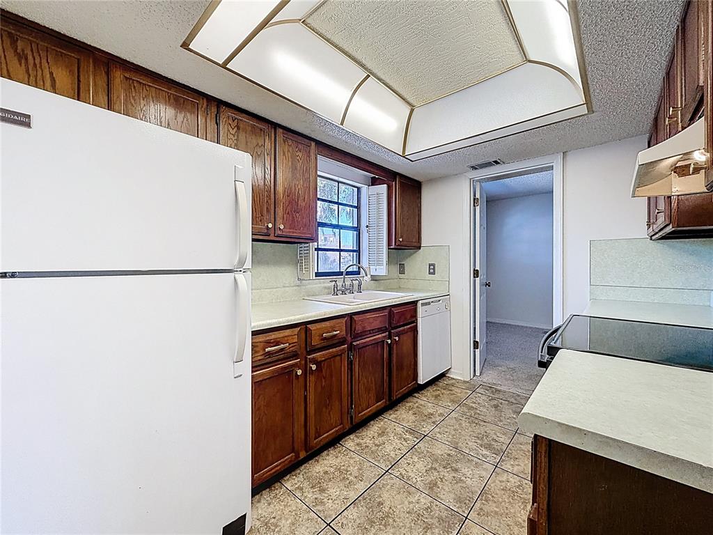500 Newell Hill Road, Unit 108A Leesburg, FL 34748 - Photo 13 of 44 a large kitchen with stainless steel appliances a sink stove and refrigerator