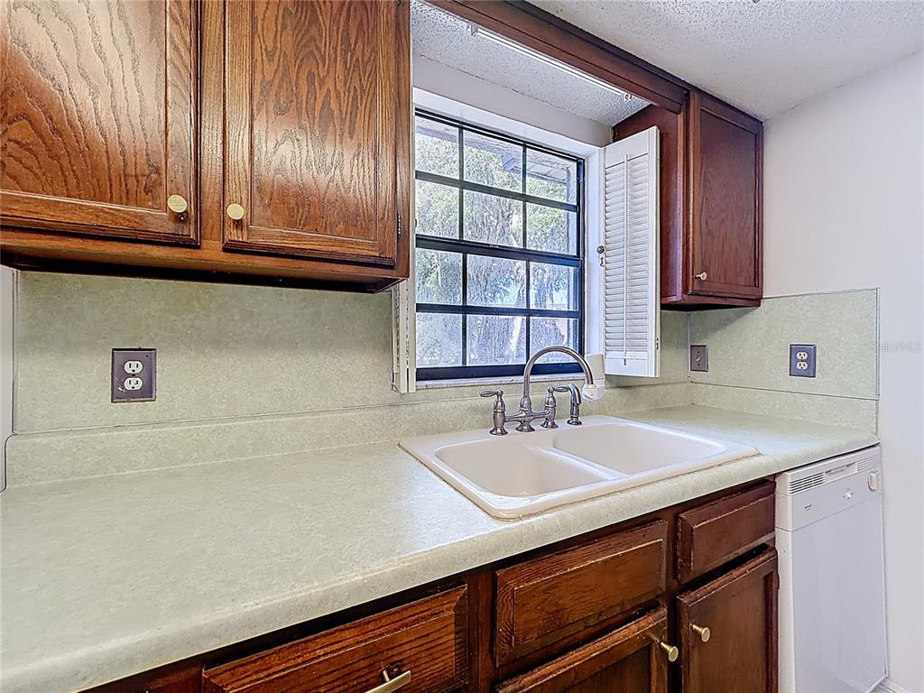 500 Newell Hill Road, Unit 108A Leesburg, FL 34748 - Photo 14 of 44 a kitchen with a sink cabinets and wooden floor