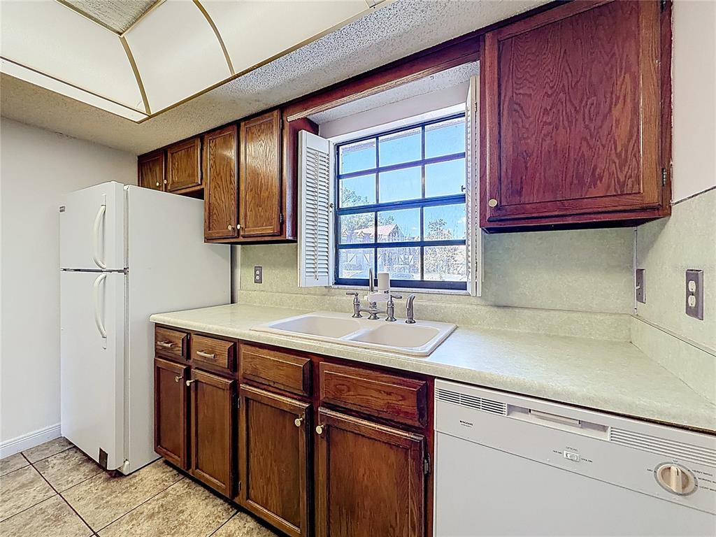 500 Newell Hill Road, Unit 108A Leesburg, FL 34748 - Photo 15 of 44 a kitchen with stainless steel appliances granite countertop a sink stove and refrigerator