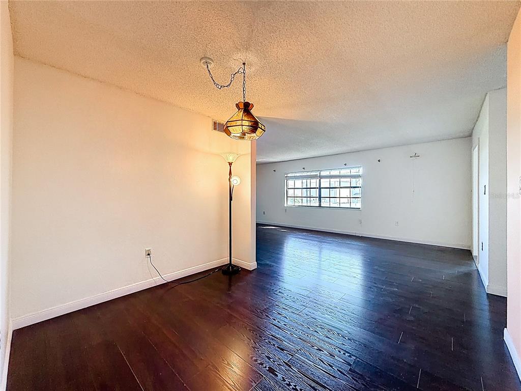 500 Newell Hill Road, Unit 108A Leesburg, FL 34748 - Photo 21 of 44 an empty room with wooden floor cabinet and windows