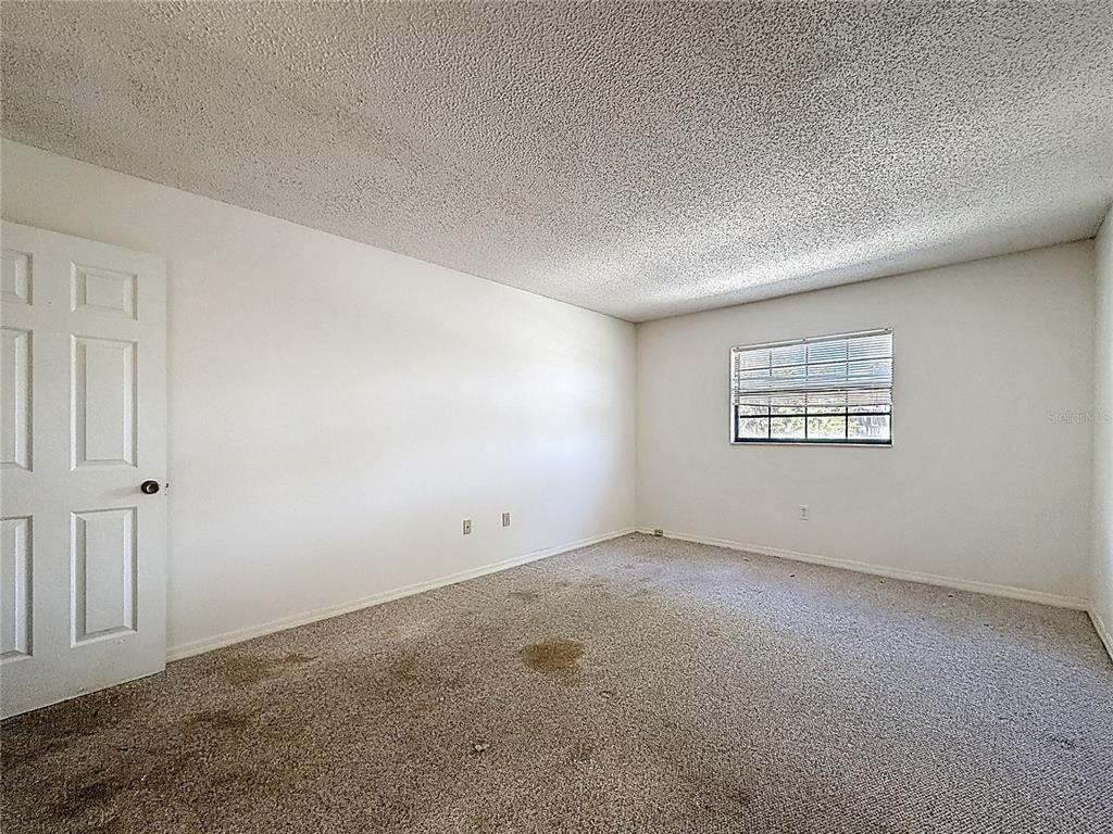 500 Newell Hill Road, Unit 108A Leesburg, FL 34748 - Photo 26 of 44 an empty room with a empty space and windows