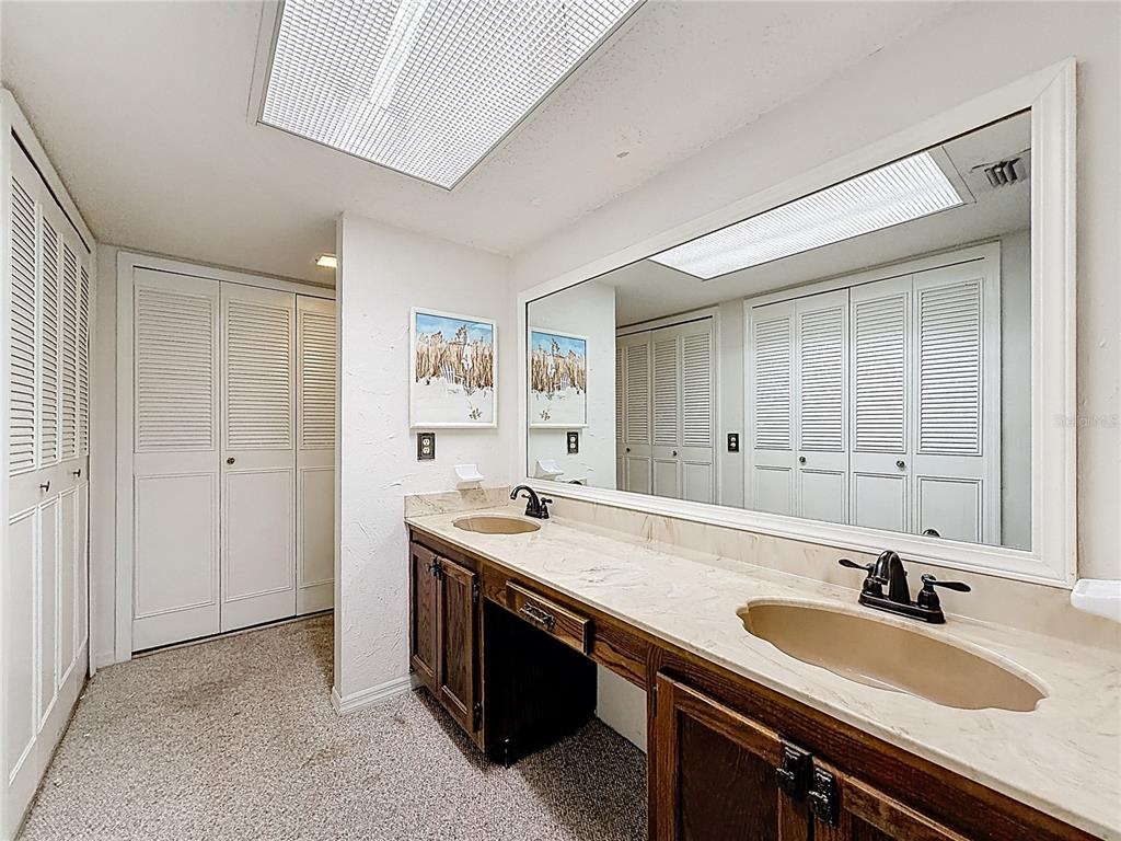 500 Newell Hill Road, Unit 108A Leesburg, FL 34748 - Photo 27 of 44 a bathroom with a sink double vanity granite tub shower and a mirror