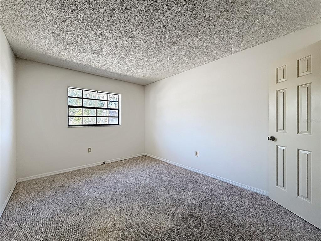 500 Newell Hill Road, Unit 108A Leesburg, FL 34748 - Photo 34 of 44 an empty room with windows