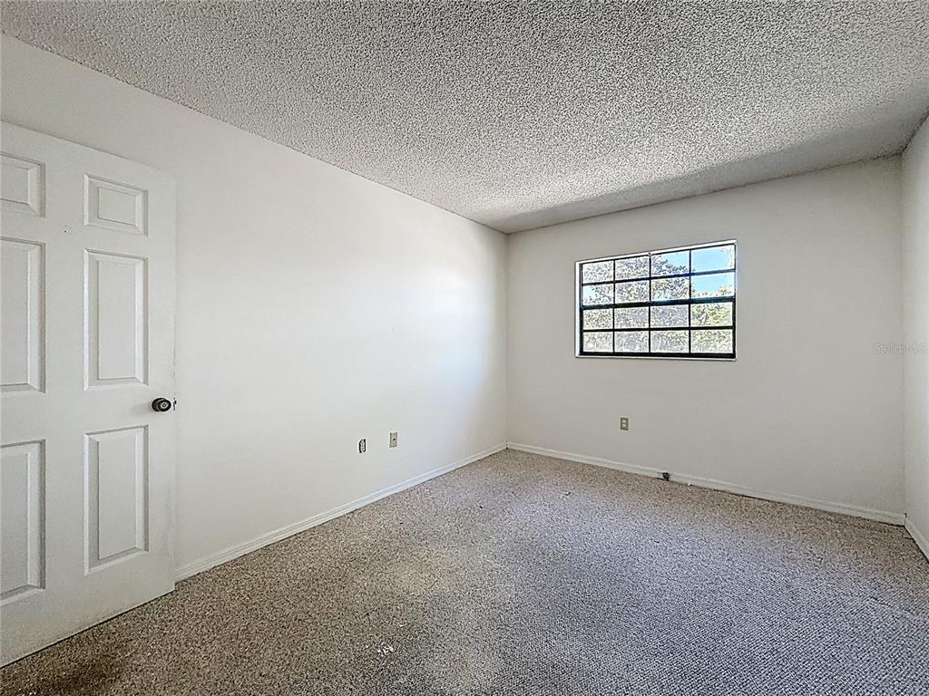 500 Newell Hill Road, Unit 108A Leesburg, FL 34748 - Photo 35 of 44 an empty room with windows