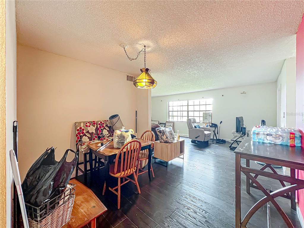 500 Newell Hill Road, Unit 108A Leesburg, FL 34748 - Photo 4 of 26 a living room with furniture and a chandelier