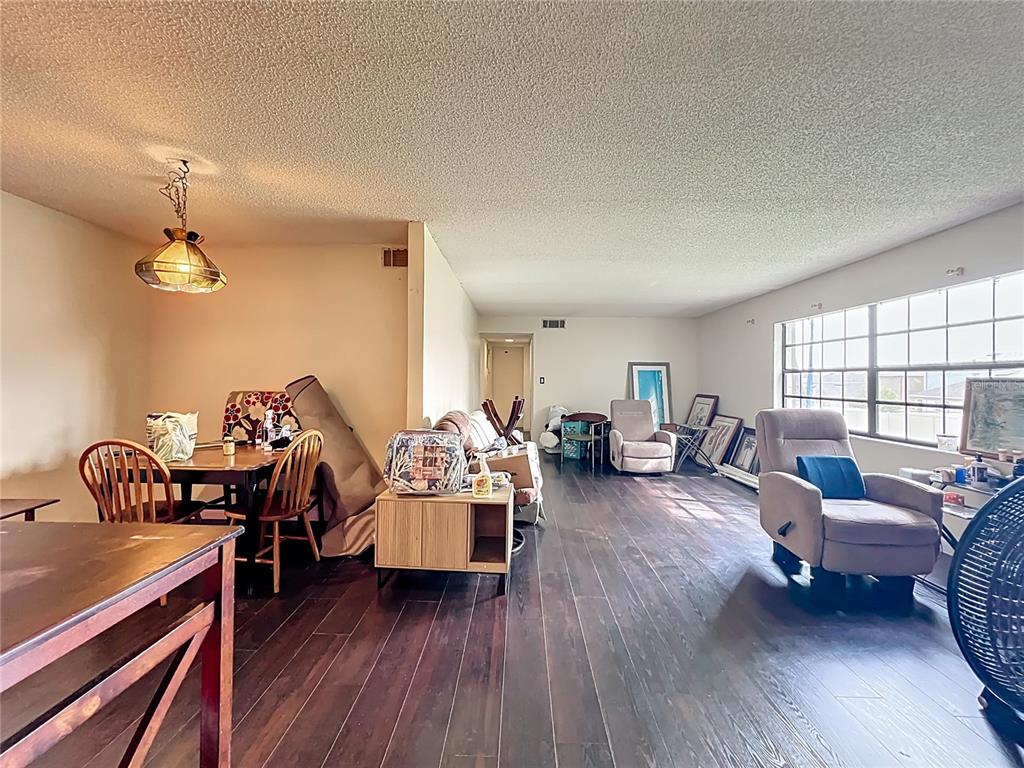 500 Newell Hill Road, Unit 108A Leesburg, FL 34748 - Photo 6 of 26 a living room with furniture fireplace and wooden floor