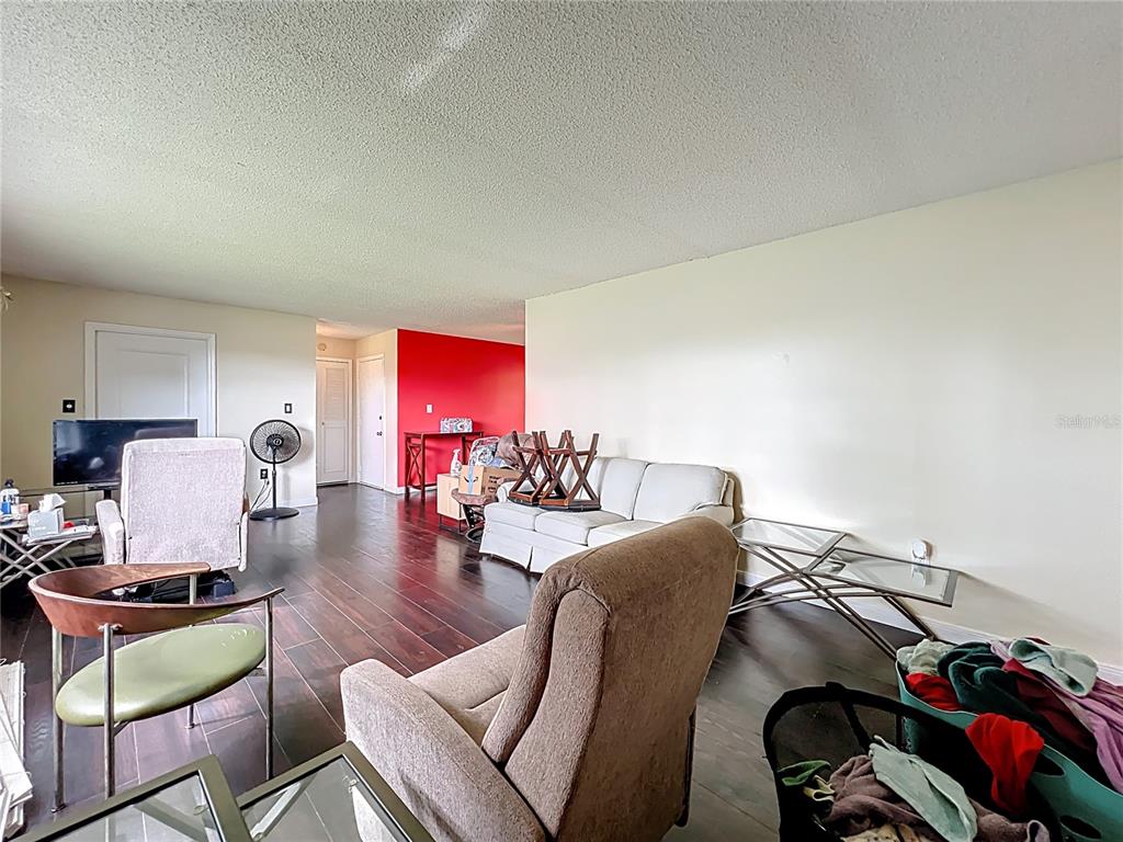 500 Newell Hill Road, Unit 108A Leesburg, FL 34748 - Photo 7 of 26 a living room with furniture and a wooden floor