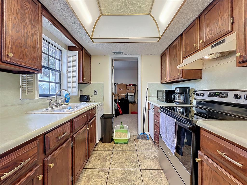500 Newell Hill Road, Unit 108A Leesburg, FL 34748 - Photo 8 of 26 a kitchen with a sink stove and cabinets