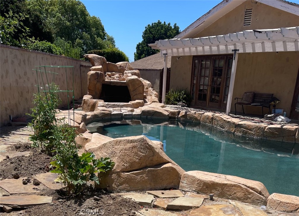 12745 Keith Place Tustin, CA 92780 - Photo 2 of 14 a view of swimming pool with a garden