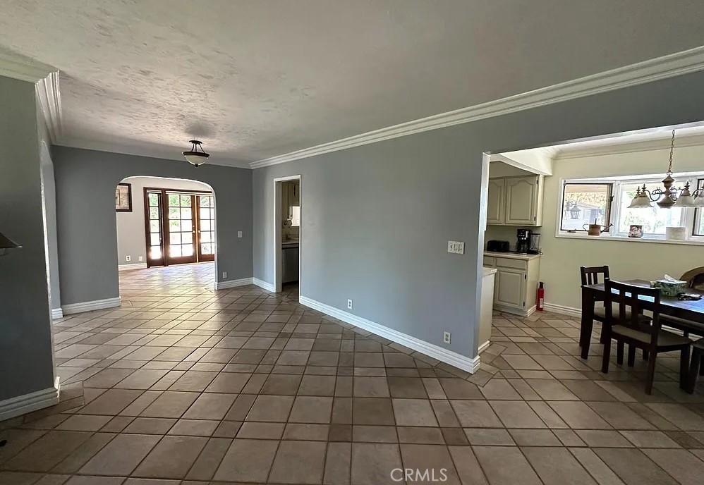 12745 Keith Place Tustin, CA 92780 - Photo 7 of 14 a view of a hallway with dining area windows and chairs