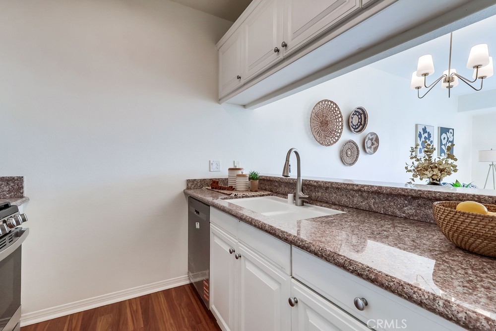 3120 Sepulveda Boulevard, Unit 412 Torrance, CA 90505 - Photo 13 of 40 a bathroom with a granite countertop sink and a mirror