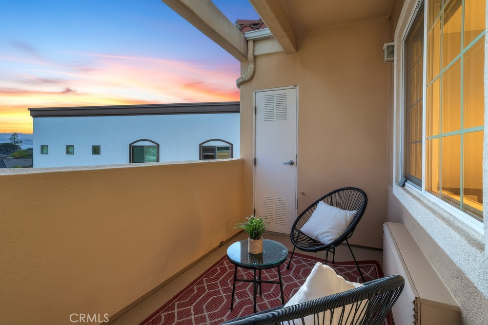 3120 Sepulveda Boulevard, Unit 412 Torrance, CA 90505 - Photo 19 of 40 a view of a balcony with chair and potted plant