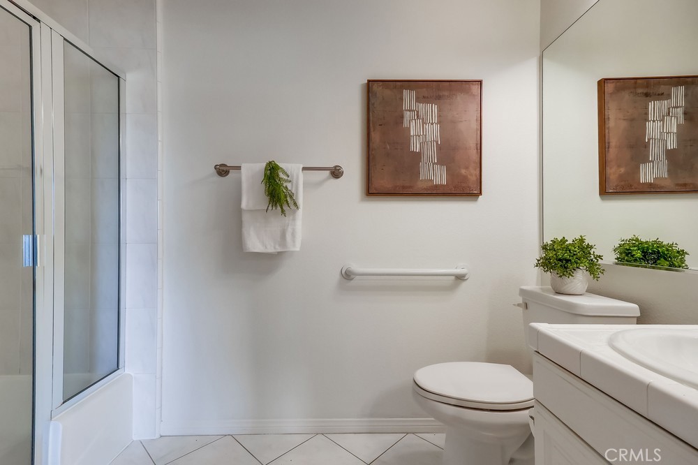 3120 Sepulveda Boulevard, Unit 412 Torrance, CA 90505 - Photo 22 of 40 a white toilet sitting next to a bathroom sink and a mirror
