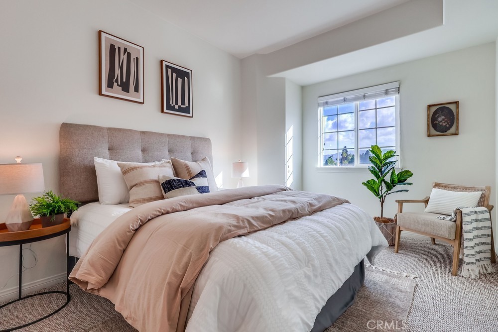 3120 Sepulveda Boulevard, Unit 412 Torrance, CA 90505 - Photo 25 of 40 a bedroom with bed and a potted plant