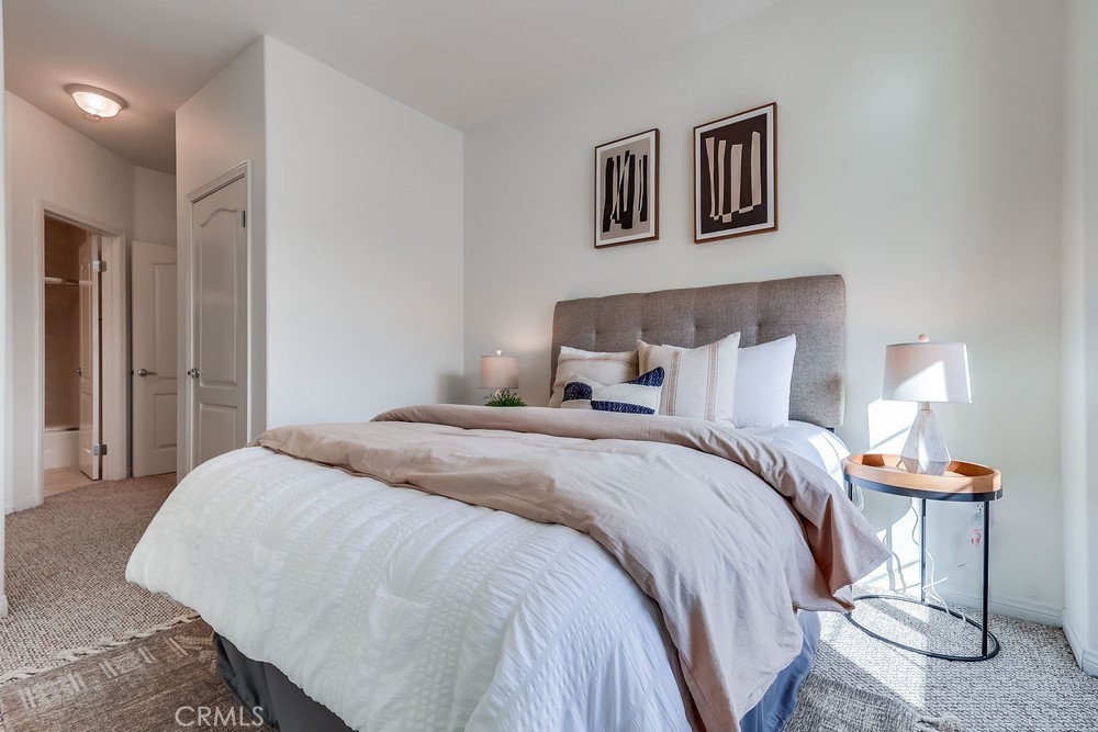 3120 Sepulveda Boulevard, Unit 412 Torrance, CA 90505 - Photo 26 of 40 a bedroom with a bed and night stand