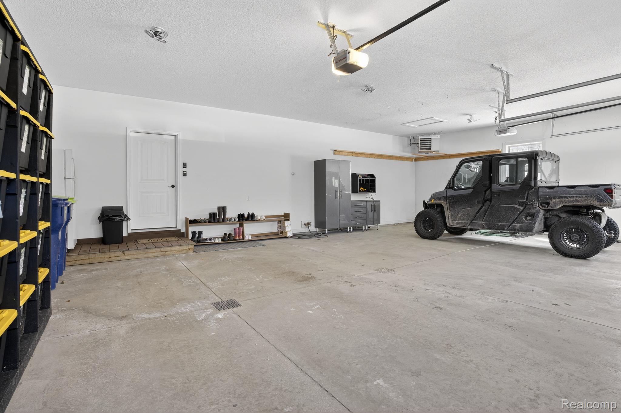 101 Highview Road Traverse City, MI 49696 - Photo 72 of 88 Garage featuring a heating unit and a garage door opener