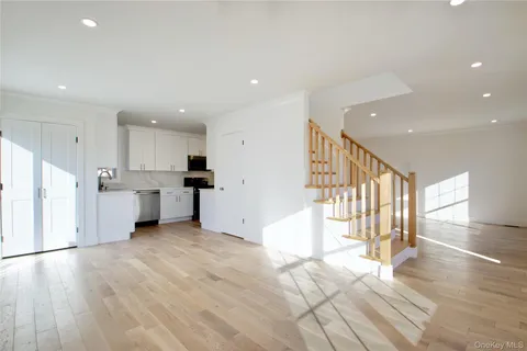a view of a kitchen with wooden floor and electronic appliances