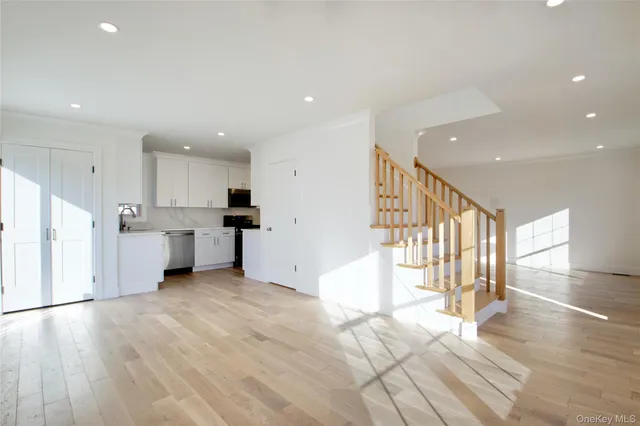 a view of a kitchen with wooden floor and electronic appliances