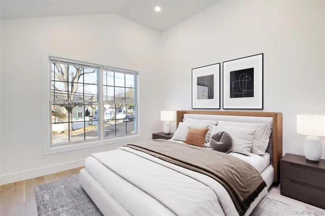 a bedroom with a large bed and a window