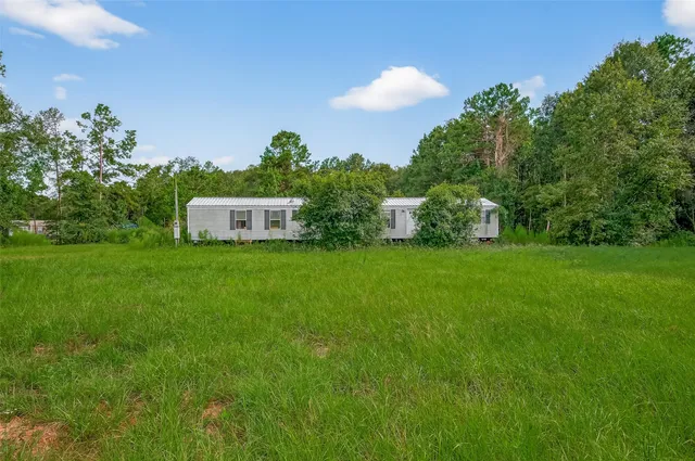 a view of a house with a big yard