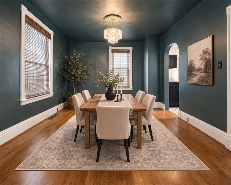 516 Eau Claire Street Butler, PA 16001 - Photo 12 of 41 a dining room with wooden floor and a chandelier