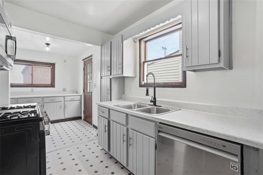 516 Eau Claire Street Butler, PA 16001 - Photo 16 of 41 a kitchen with a sink a stove and cabinets