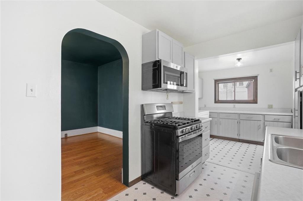 516 Eau Claire Street Butler, PA 16001 - Photo 17 of 41 a kitchen with granite countertop a stove and a microwave