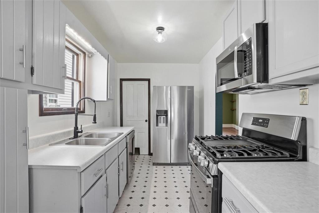 516 Eau Claire Street Butler, PA 16001 - Photo 18 of 41 a kitchen with stainless steel appliances a sink stove and refrigerator