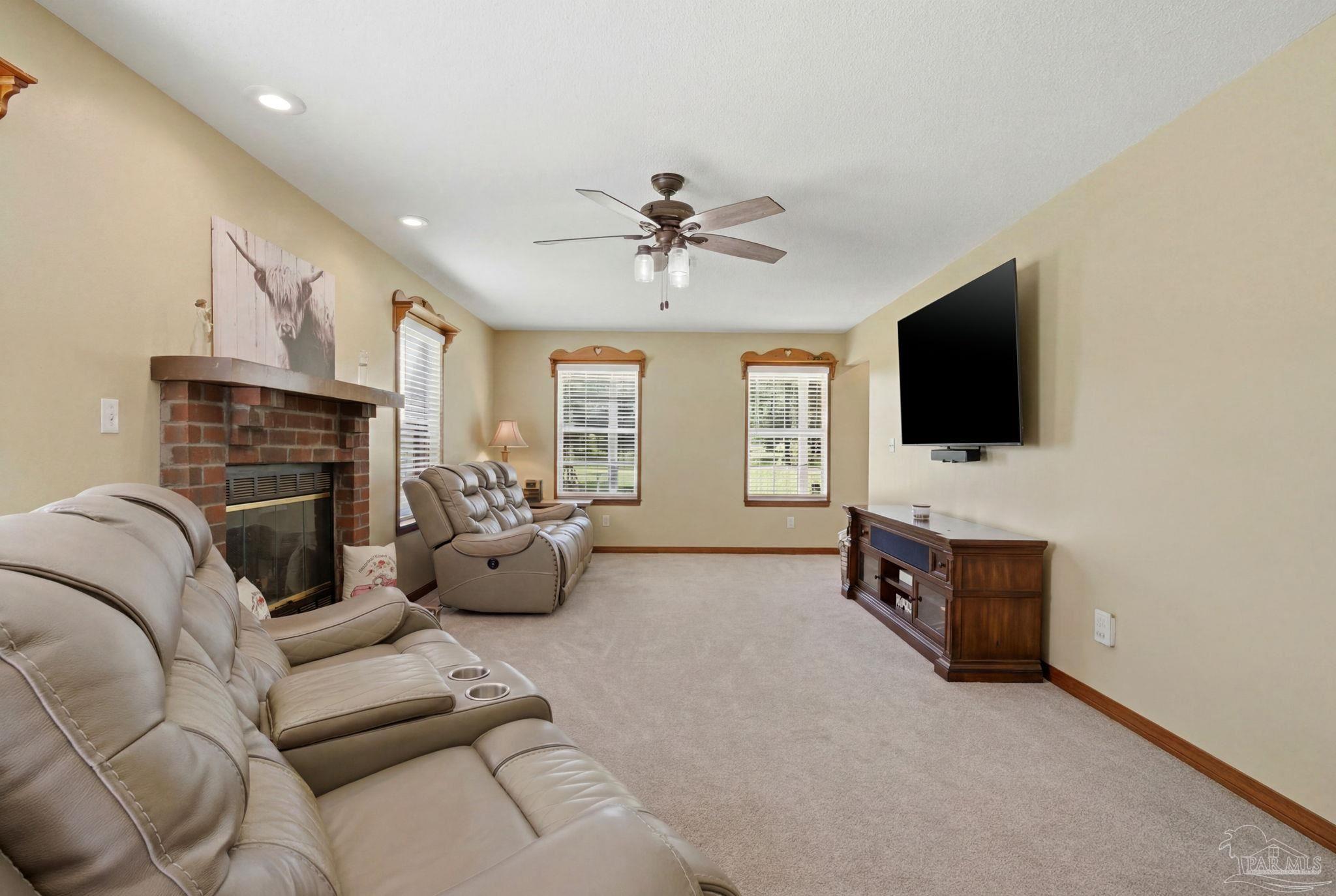 6870 Martin Road Milton, FL 32570 - Photo 17 of 48 a living room with furniture fireplace and flat screen tv