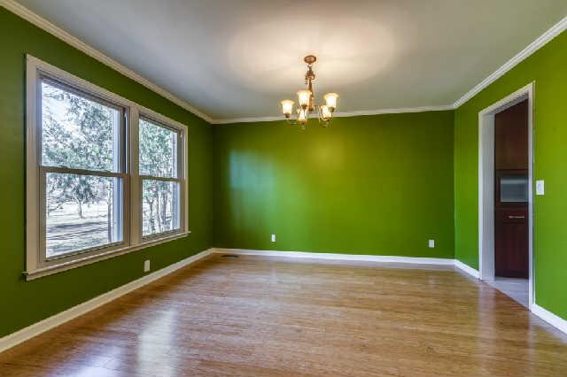 Separate dining room is a room with a view of the wooded private acreage in front!