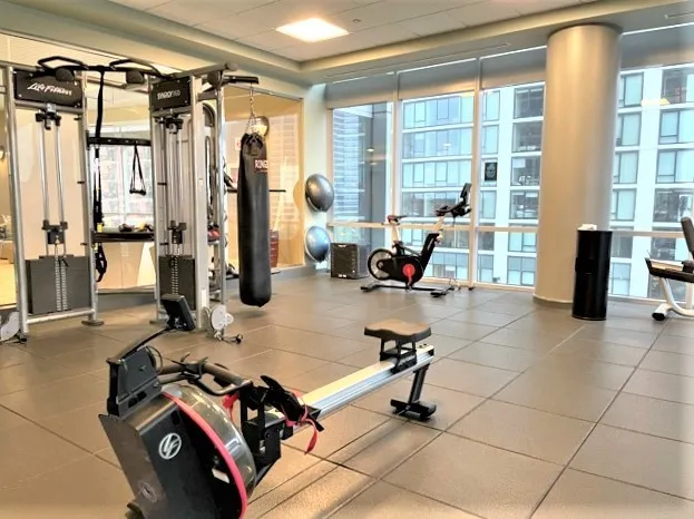 a room with gym equipment and a flat screen tv