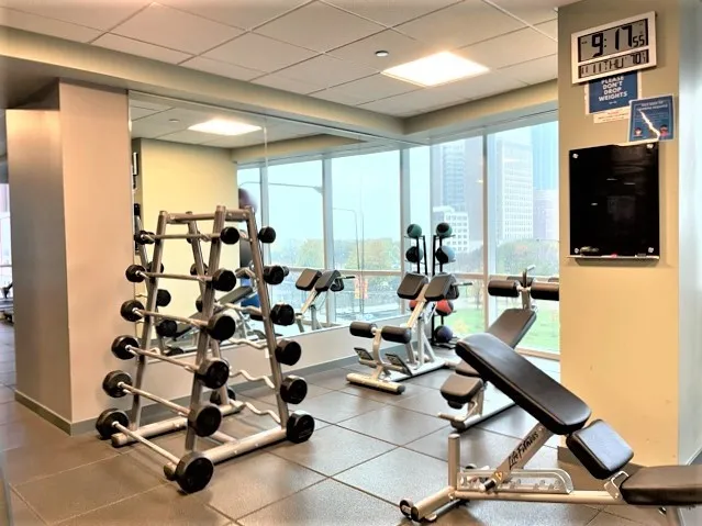 a view of a hall with dining table and chairs