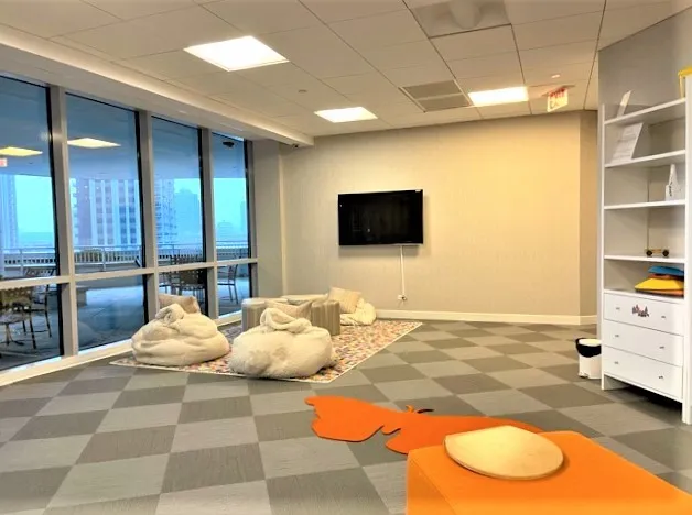 a living room with furniture gym equipment and a rug