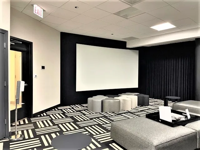 a room with lots of chairs and mirrors