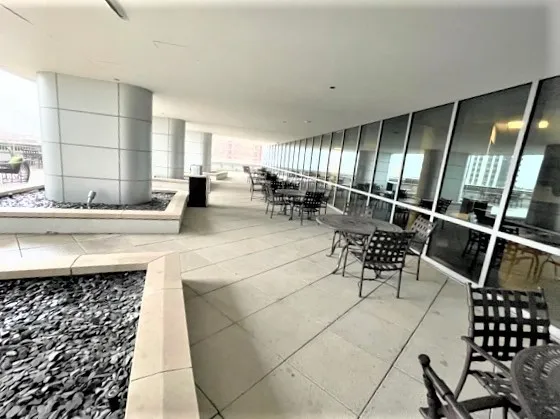 a large living room with furniture and a floor to ceiling window