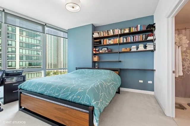 a bed sitting in a bedroom next to a large window