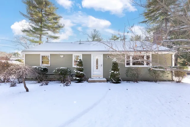 a view of a house with yard and sitting area