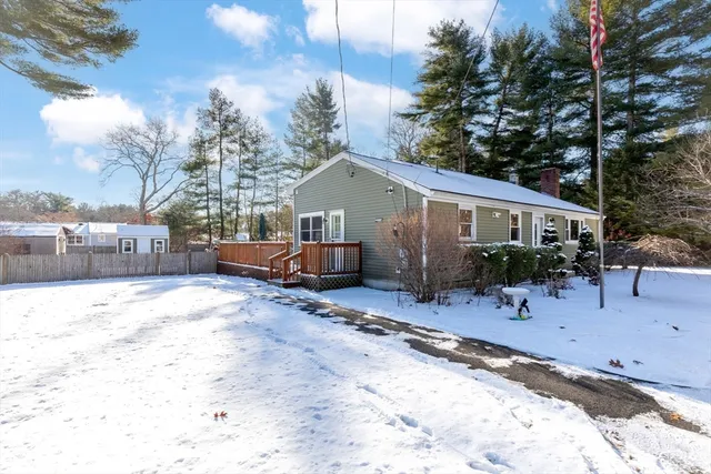 a view of a house with a yard covered in snow