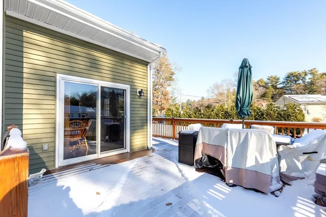 a view of a roof deck with couches and wooden floor