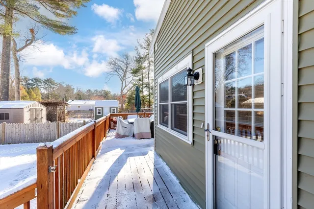 a view of a balcony with wooden floor and fence