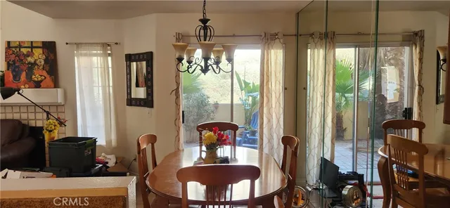 a view of a dining room with furniture and chandelier