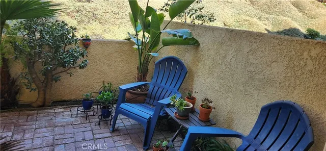 a view of a chairs and table in patio