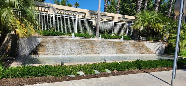 front view of a house with a yard and potted plants