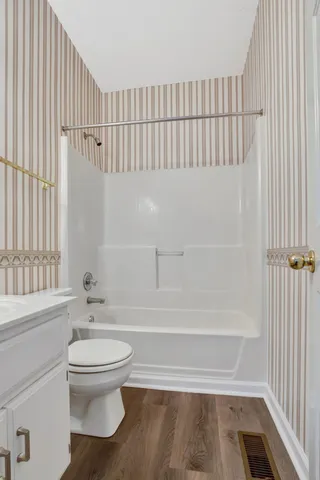 a bathroom with a toilet and a bathtub