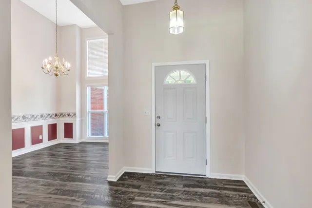 a view of livingroom with hardwood floor and kitchen view