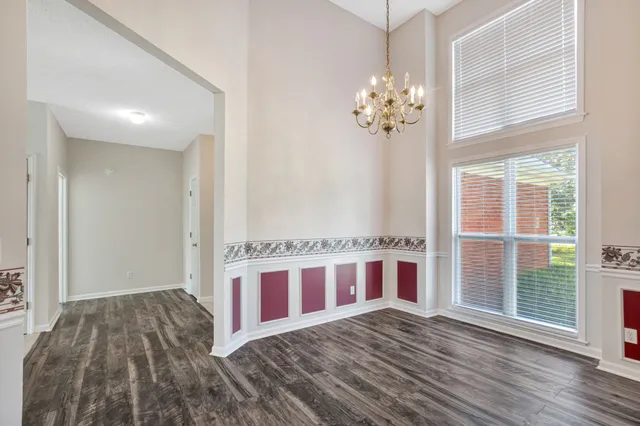 a view of a bedroom with wooden floor