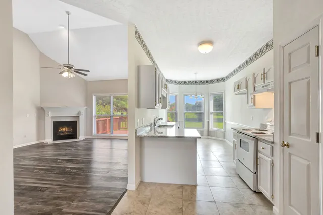 a large kitchen with granite countertop a large counter top and appliances