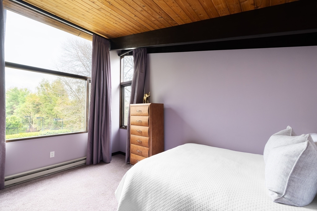 363 Brookline Street Newton, MA 02459 - Photo 13 of 30 a bedroom with a bed and a large window