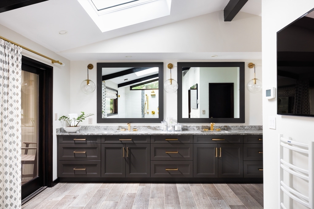 363 Brookline Street Newton, MA 02459 - Photo 18 of 30 a bathroom with a granite countertop sink and a mirror