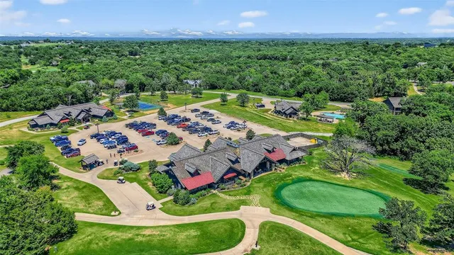 an aerial view of a house with garden space and street view